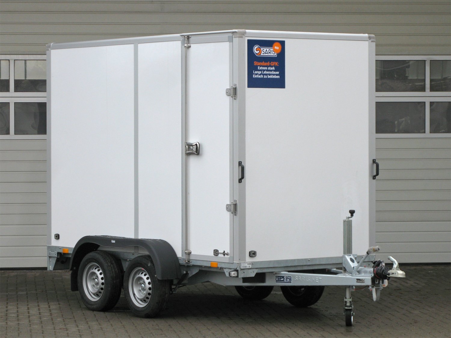 Saris Kofferanhänger GO 306 154 200 2000 2 – Auffahrrampe, Seitentüre GFK Außen – Ladefläche 306 × 154 cm – 2000 kg – Tandemachser – Ansicht 1